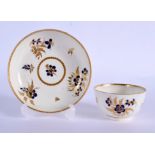 18th c. Worcester teabowl and saucer painted with blue flowers and highlighted with gilded leaves un