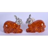 A PAIR OF SILVER AND AMBER RABBIT SALTS. 6 cm x 5 cm.