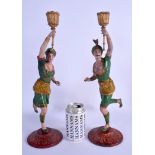 A PAIR OF ANTIQUE PAINTED SPELTER FIGURES OF TURKISH MALES formed as candlesticks. 38 cm high.