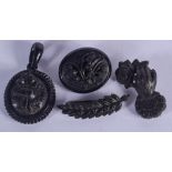 FOUR ANTIQUE JET BROOCHES. Largest 4 cm x 4.5 cm. (4)