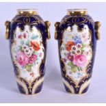 English porcelain fine pair of urn shaped vases with ring handled lavishly painted with flowers surr