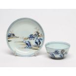 A NANKING CARGO CHINESE PORCELAIN TEA BOWL AND SAUCER painted in underglaze blue and overpainted