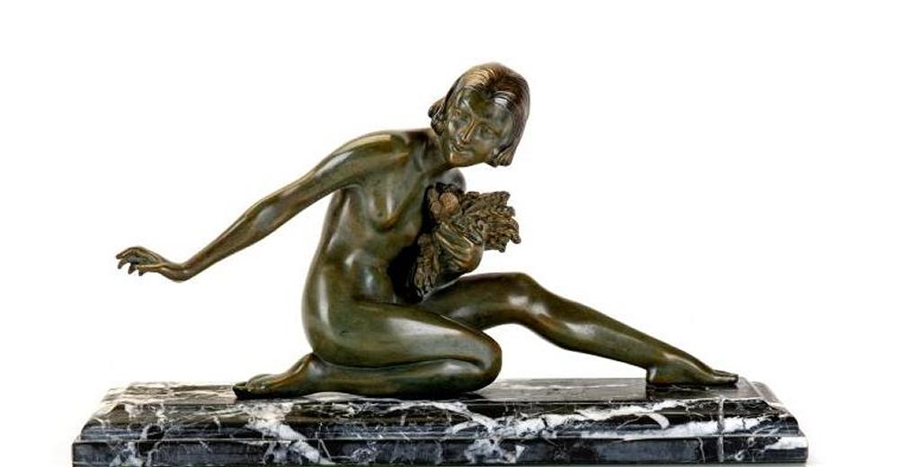 AFTER ARMAND GODARD - an Art Deco bronze figure modelled as a young female nude kneeling on her