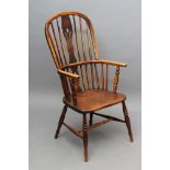 A WINDSOR SPINDLE BACK ARMCHAIR in ash and elm, early/mid 19th century, of high hooped form with