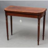 A GEORGIAN MAHOGANY FOLDING CARD TABLE, c.1800, the rounded oblong and banded top with stringing