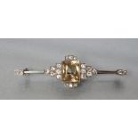 AN ART DECO BROOCH, the central square cut citrine collet set to a bar with round brilliant cut