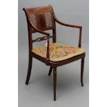 AN EDWARDIAN MAHOGANY CANED ELBOW CHAIR, of Georgian design with stringing, scroll back uprights,