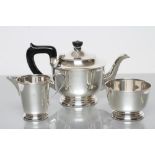 A SILVER THREE PIECE TEA SERVICE, maker Viners, Sheffield 1939, of rounded cylindrical form on a low