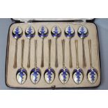 A MATCHED SET OF TWELVE SILVER GILT AND ENAMEL COFFEE SPOONS, maker Turner & Sons, Birmingham