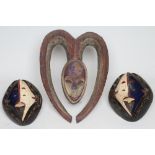 A CONFON KWELE "FOREST SPIRIT" MASK, with typical heart surround and patinated painted surface,