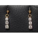 A PAIR OF DIAMOND DROP EARRINGS, each unmarked ball stud stamped 9ct and hung with three graduated