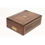 AN EARLY VICTORIAN ROSEWOOD WRITING BOX of rounded oblong form with pierced brass banding, hinged