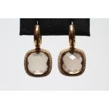 A PAIR OF MODERN EARRINGS by David M Robinson, the faceted cushion cut stones