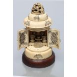 A JAPANESE IVORY SHRINE, Meiji period, the cylindrical temple with carved and pierced dragon cupola,