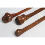 THREE WALKING STICKS, 19th century, one with carved head pommel of a bearded man with ebony dot