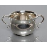 A SILVER PORRINGER, maker Page, Keen & Page, London 1931, of squat baluster form with two scroll
