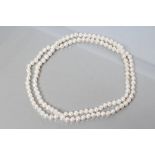 A SINGLE STRING OF CULTURED PEARLS, 22" long (Est. plus 21% premium inc. VAT)