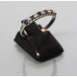 A SAPPHIRE AND DIAMOND HALF HOOP RING, the six sapphires and five diamonds alternately set to a