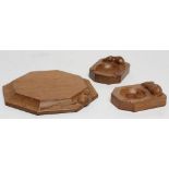 A ROBERT THOMPSON ADZED OAK SMALL CHOPPING BOARD/STAND of octagonal form, the dished sides with