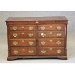 A GEORGIAN OAK AND MAHOGANY BANDED LANCASHIRE DRESSER, c.1800, the hinged plank lid over banded