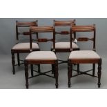 A SET OF FOUR REGENCY MAHOGANY DINING CHAIRS, the reeded uprights enclosing a similar top rail