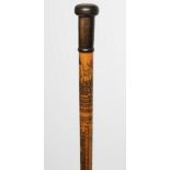 AN EGYPTIAN PENWORK WALKING CANE with polished horn knop, the tapering shaft with intricately