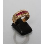 A RUBY AND DIAMOND HALF HOOP RING, the six square cut rubies channel set to small round brilliant