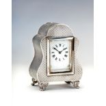 A LATE VICTORIAN SILVER MANTEL TIMEPIECE, maker William Comyns, London 1901, the oblong white enamel