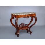 A VICTORIAN CARVED WALNUT CONSOLE TABLE of serpentine oblong form with marble top, leaf carved