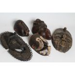 A COLLECTION OF FIVE TRIBAL MASKS, including a baboon and monkey, cast metal leopard, typical spirit