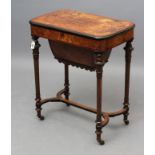 A VICTORIAN WALNUT AND EBONISED SEWING TABLE, of rounded oblong form, with stringing, hinged lid