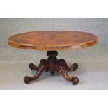 A VICTORIAN WALNUT LOO TABLE, the moulded edged quarter veneered tip up top on lobed baluster
