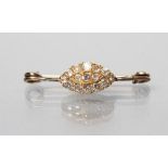 A VICTORIAN DIAMOND BROOCH, the marquise shaped panel set with fifteen mixed cut old stones to a