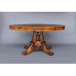 A VICTORIAN WALNUT BREAKFAST TABLE, the quarter veneered lobed oval tip up top on four shaped