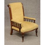 A GENTLEMAN'S VICTORIAN OAK FRAMED ARMCHAIR upholstered in gold chenille, the padded back with