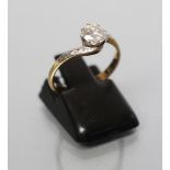 A SOLITAIRE DIAMOND RING, the round brilliant cut stone of approximately 0.6cts claw set to scroll