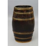 A COOPERED OAK STICK BARREL of oval form with brass banding, 11 1/2" x 23 1/2" (Est. plus 21%