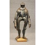 A SUIT OF 17TH CENTURY STYLE CUIRASSIER ARMOUR, the helmet with mild comb, open eyelets, large