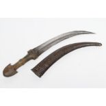 A JAMBIYA, 19th century, with 10 1/2" curved blade, shaped rhino horn hilt of typical form and