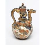 A SATSUMA EARTHENWARE EWER AND COVER, Meiji period, of baluster form with tall neck, the dragon