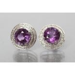 A PAIR OF AMETHYST AND DIAMOND STUD EARRINGS, the round cut amethysts totalling approximately 5.