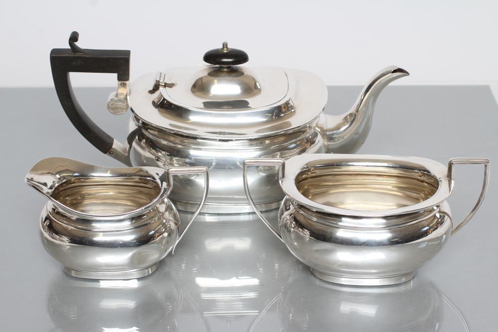 A SILVER THREE PIECE TEA SERVICE, maker Jones & Crompton, Birmingham 1912, of plain rounded oblong