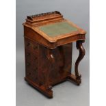 A VICTORIAN WALNUT DAVENPORT, the raised stationery compartment with pierced fret gallery on