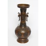A JAPANESE BRONZE VASE of baluster form with cast and applied dragon handles and panels of