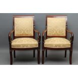 A PAIR OF MAHOGANY FRAMED EMPIRE STYLE ARMCHAIRS, French 19th century, upholstered in yellow silk