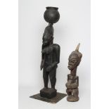 AN AFRICAN TRIBAL MATERNITY FIGURE carved in hard wood with head spike, 25" tall, together with a