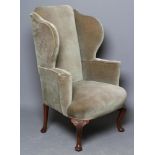 A BEECH FRAMED WING ARMCHAIR of early Georgian design upholstered in pale green dralon, arched back,