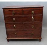 A REGENCY MAHOGANY CHEST of two short and three long cockbeaded drawers, moulded edged banded top,