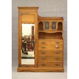 A GENTLEMAN'S ARTS AND CRAFTS STYLE OAK WARDROBE, the moulded cornice over mirrored door with copper