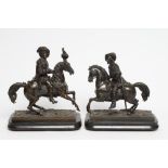 A PAIR OF BRONZE EQUESTRIAN FIGURES, modelled as 17th century noblemen astride a fiery steed, on